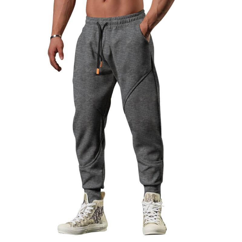 Calça de academia masculina jogger cinza escuro com costura anatômica e cordão preto, ideal para treino funcional e conforto urbano