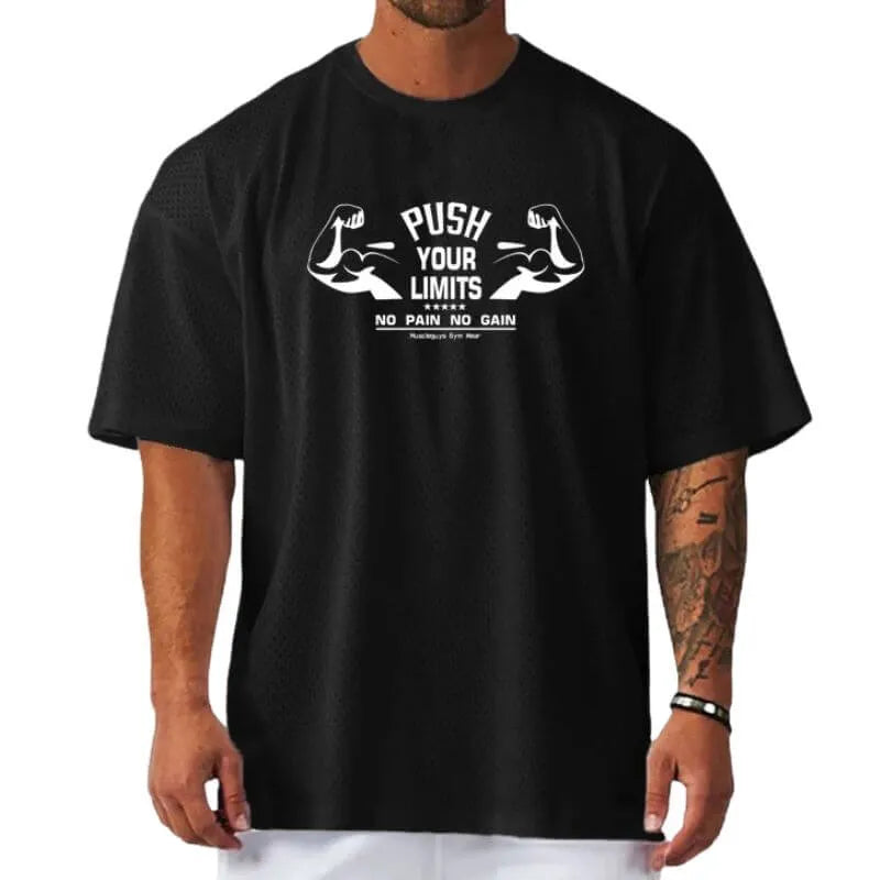 Camiseta oversized masculina preta com frase PUSH YOUR LIMITS e estampa motivacional para treino